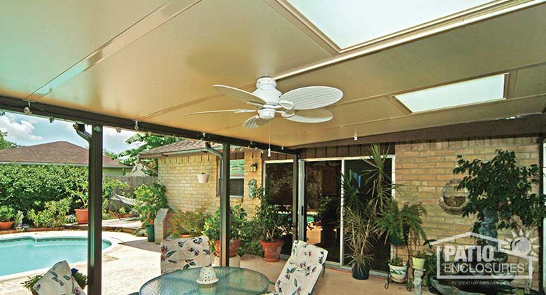 Sandstone patio cover with glass roof panels for added natural light.