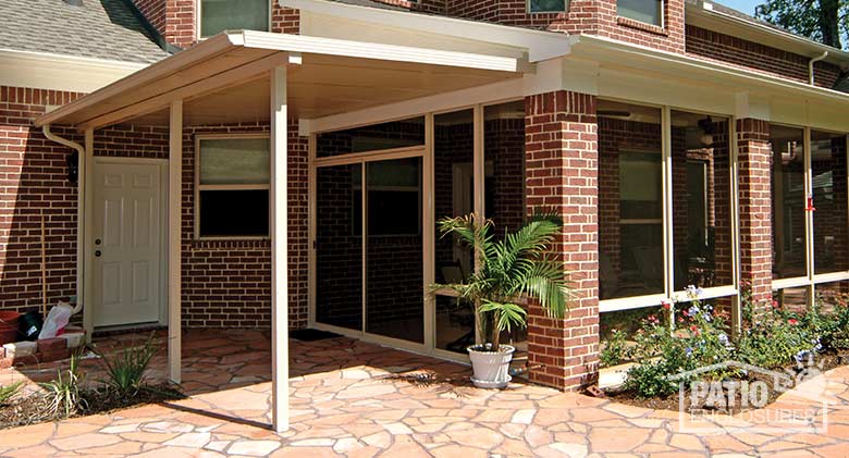 Sandstone patio cover attached to existing roof of enclosed porch.