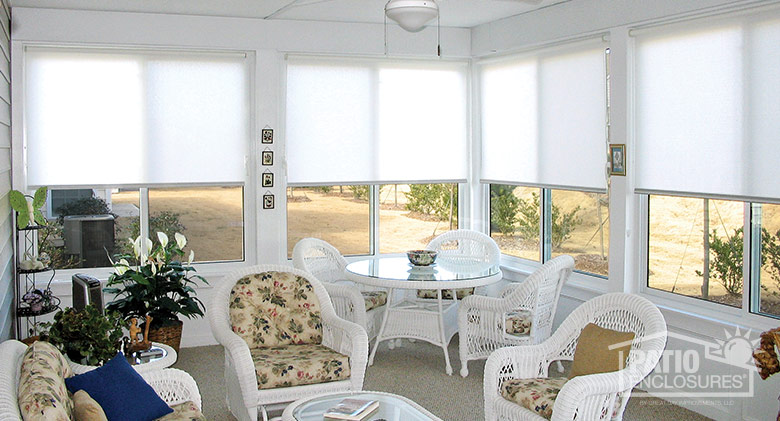 Sunroom Decorated with White Wicker Furniture and Pastel Fabric