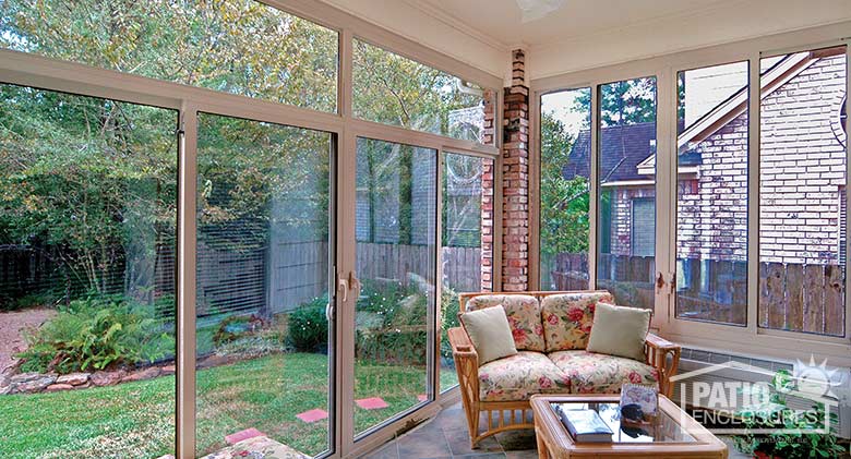 Sandstone all season sunroom with aluminum frame enclosing an existing covered patio.