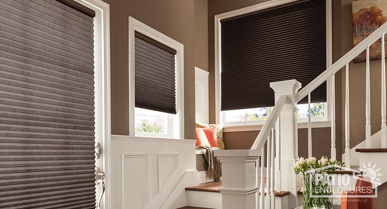 Cellular shades with cordless lift, Solitude blackout fabric, and walnut shell.
