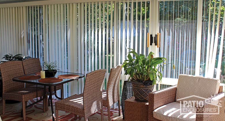 White vertical blinds provide privacy and UV protection.
