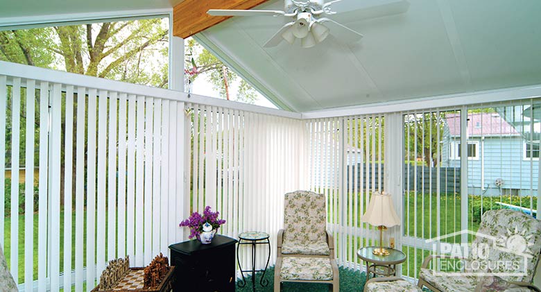 White vertical blinds provide privacy while open glass in a gable roof allows for ample natural light.