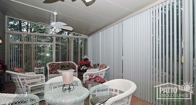 White vertical blinds in a sunroom with a single-slope roof.