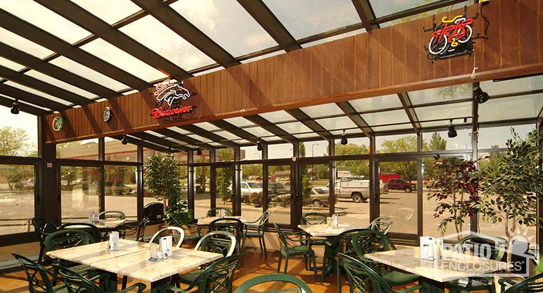 Interior view of bronze solarium with single-slope roof at Dillnger’s Food & Spirits.