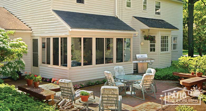 Three season room in white with solid knee wall enclosing an existing covered porch.