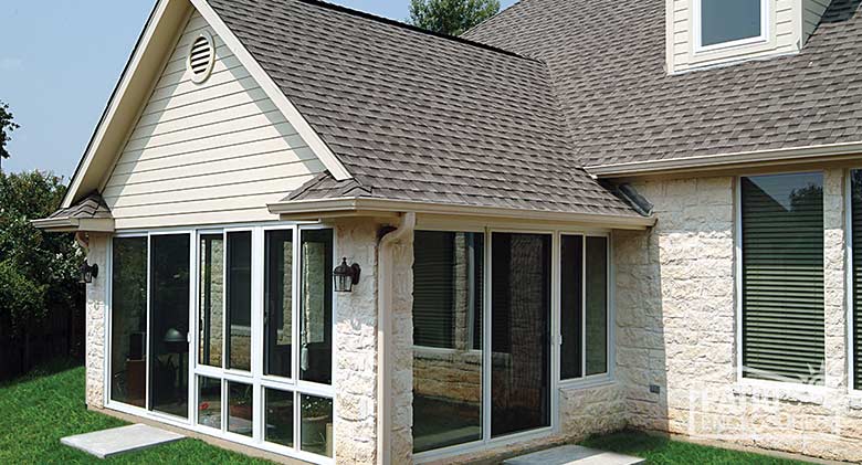 Elite three season room in white with insulated glass enclosing an existing covered porch.