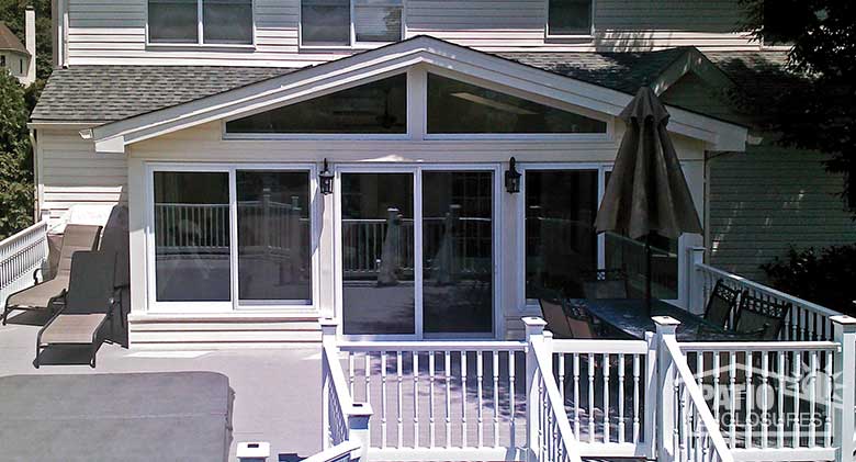 White four season sunroom with vinyl frame, solid knee wall and custom gable roof.