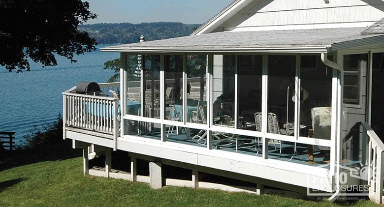 White screen room with knee wall and shingled, single-slope roof.