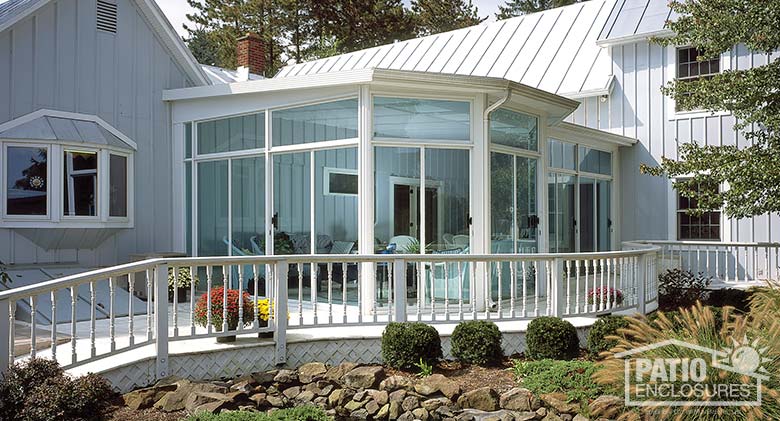 White three season sunroom with transoms and single-slope roof.