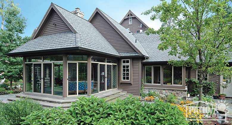 Sandstone three season room enclosing an existing covered patio.