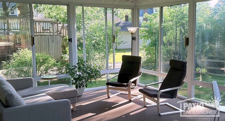 White three season room with glass knee wall enclosing an existing covered patio.