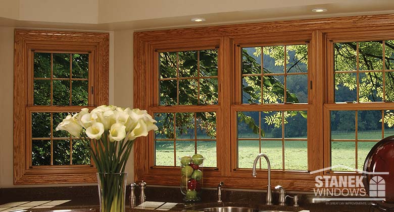 Double-hung windows with woodgrain interior finish and interior colonial grids.