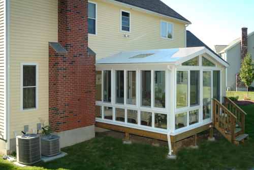 Outside View Of A Sunroom Addition With Vaulted Ceiling