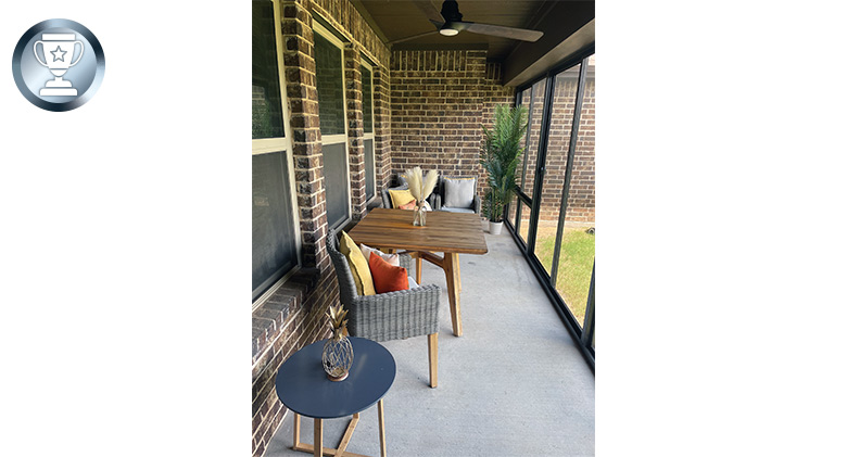 Interior of an enclosed patio with chairs and tables.