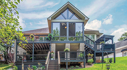 GRAND PRIZE 2025: Three images of a large brown sunroom with gable roof, exterior and interior with blue, orange, and tan furnishings.