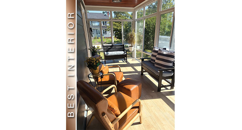 Best Interior: Three-season room with two loveseats with striped pillows, wood floor, two leather chairs and ottoman.