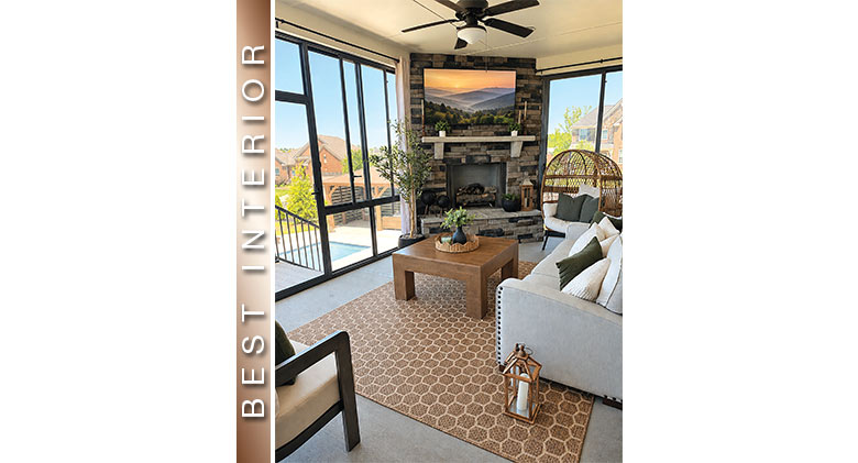 Best Interior: Small three-season room with seating area, fireplace, and ceiling fan. View of the neighborhood.