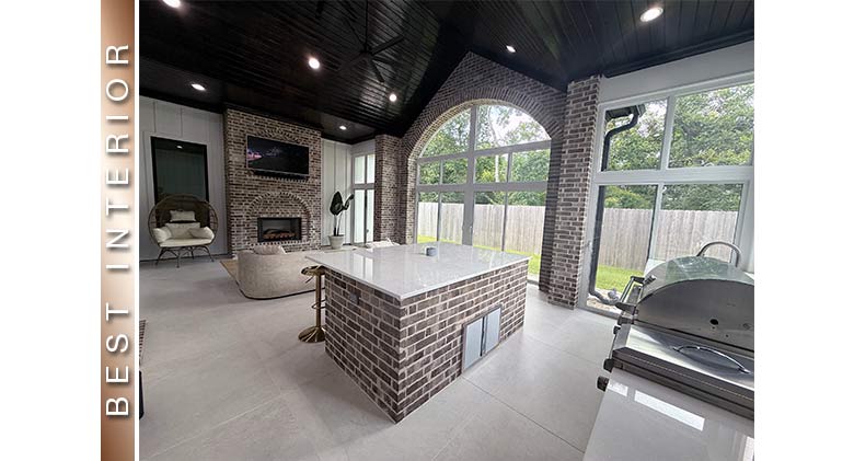Best Interior: Large open patio enclosure with arched windows, kitchen island, sofa, TV, and fireplace.
