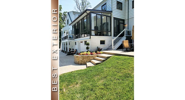 Best Exterior: Brown framed second-story three-season room on white home with patio, built-in planter, & stairs to the side.
