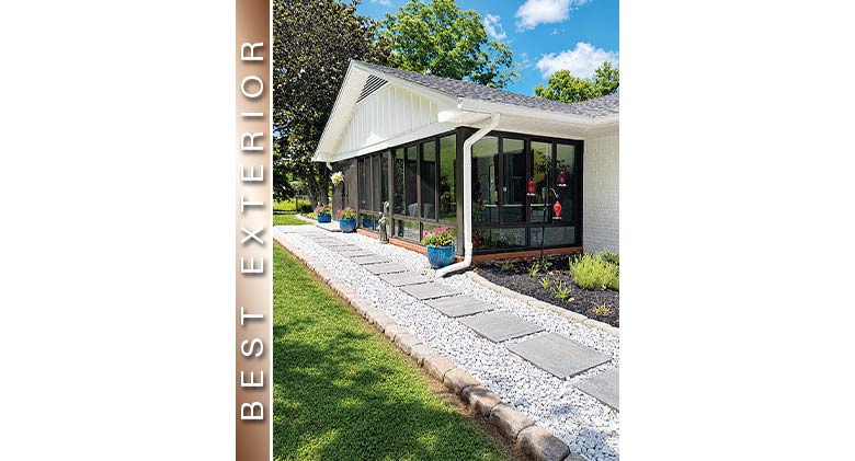 Best Exterior: Exterior of brown three-season patio enclosure with gable roof, stone walkway in front.
