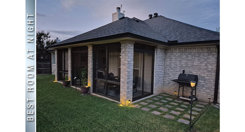Best at Night: Outdoor lighting surrounds the exterior of a screen room patio enclosure with bronze frame.
