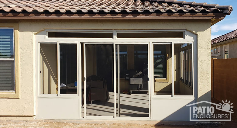 The sun streaming into a corner Arizona room with tile roof, solid knee wall and transom.