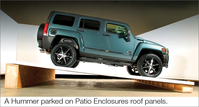 A hummer parked on Patio Enclosures roof panels at an angle to show the strength of the roofing.