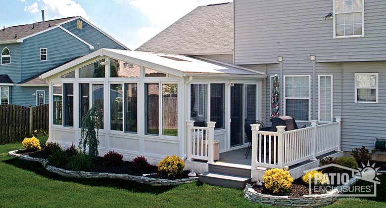 White four season sunroom with vinyl frame, solid knee wall and gable roof with glass roof panels.