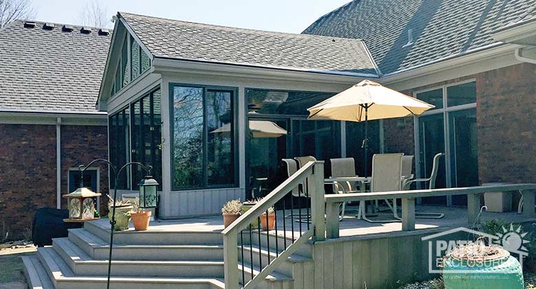 Bronze four season sunroom with aluminum frame enclosing an existing covered porch.