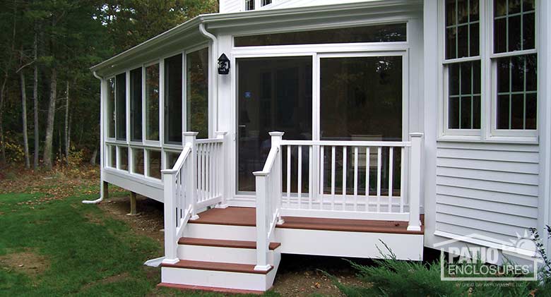 White four season sunroom with vinyl frame, glass knee wall and single-slope roof.