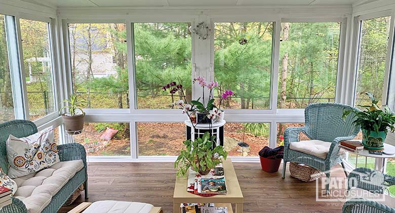 White four season sunroom with vinyl frame, glass knee wall and single-slope roof.