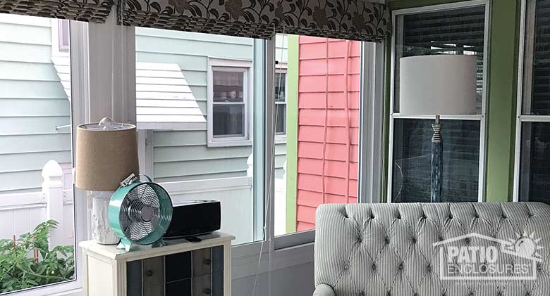 White four season sunroom with vinyl frame, solid knee wall and single-slope roof.