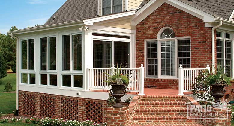 White four season sunroom with vinyl frame, glass knee wall and single-slope roof.