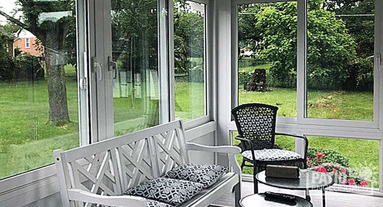 White four season sunroom with vinyl frame, glass knee wall and gable roof.