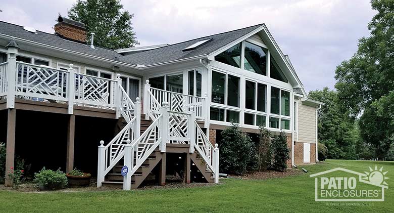 White all season sunroom with vinyl frame enclosing an existing screened-in porch.