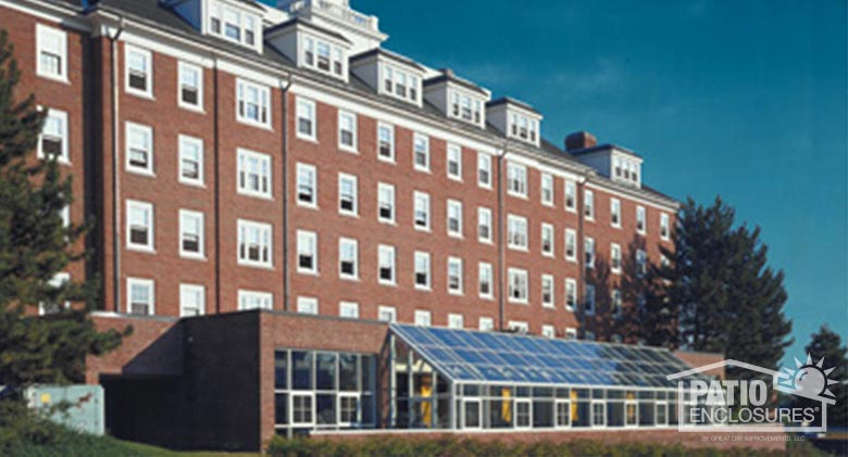 White solarium with single-slope roof at Tufts University in Medford, MA.