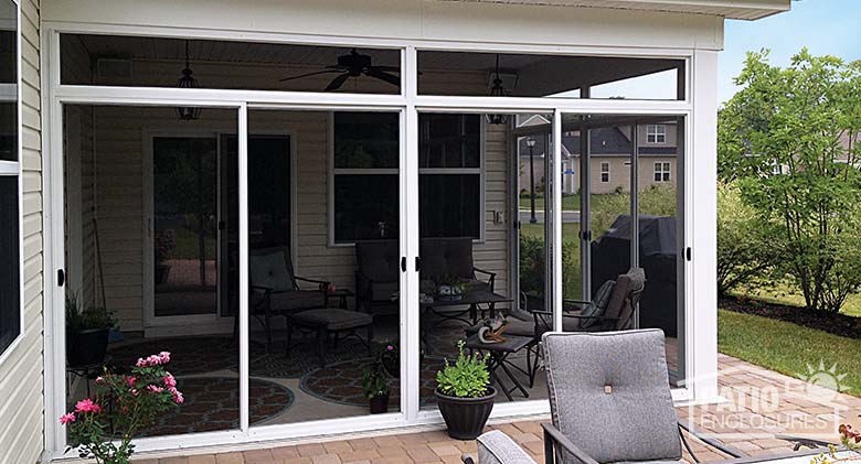 Screen room in white with transom enclosing an existing covered patio.