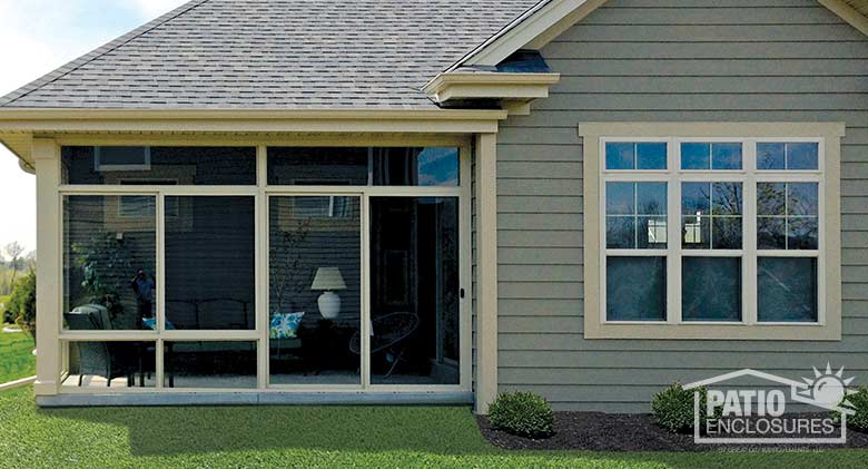 Three season room in sandstone with transom enclosing an existing covered patio.