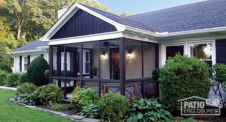 Screen room in bronze with knee wall enclosing an existing front porch.