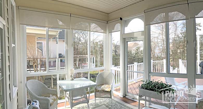 Elite three season room in white with glass knee wall enclosing an existing screened porch.