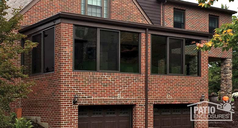 Four season room in bronze with aluminum frame enclosing an existing front porch.