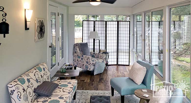 Elite three season room in white with glass knee wall enclosing an existing screened porch.