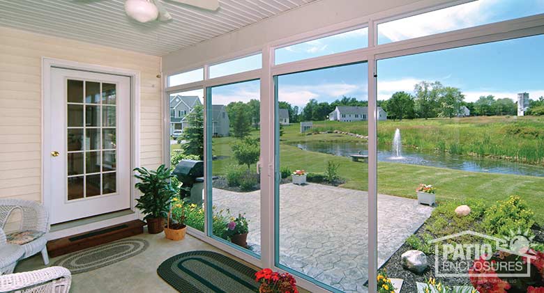 Interior view of four season room in white with vinyl frame and transom enclosing an existing back porch.