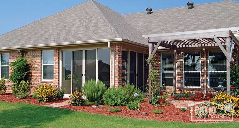 Three season room in sandstone enclosing an existing covered patio.