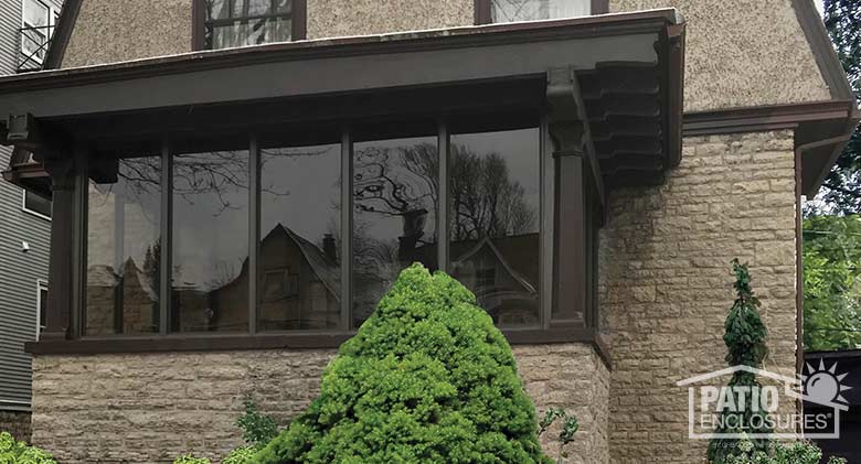 Three season room in bronze enclosing an existing front porch.