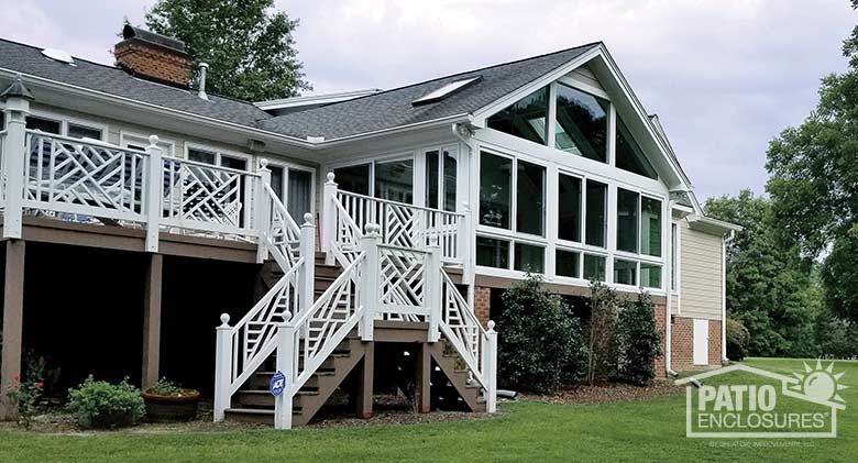 White four season sunroom with vinyl frame and glass knee wall enclosing an existing screened-in porch.