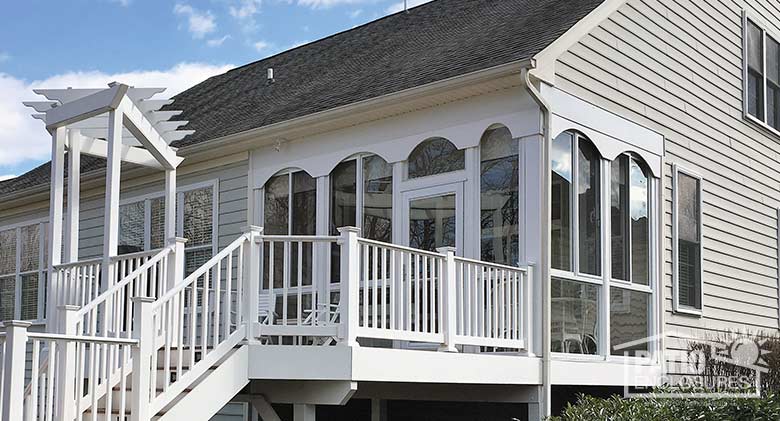 Elite three season room in white with glass knee wall enclosing an existing screened porch.