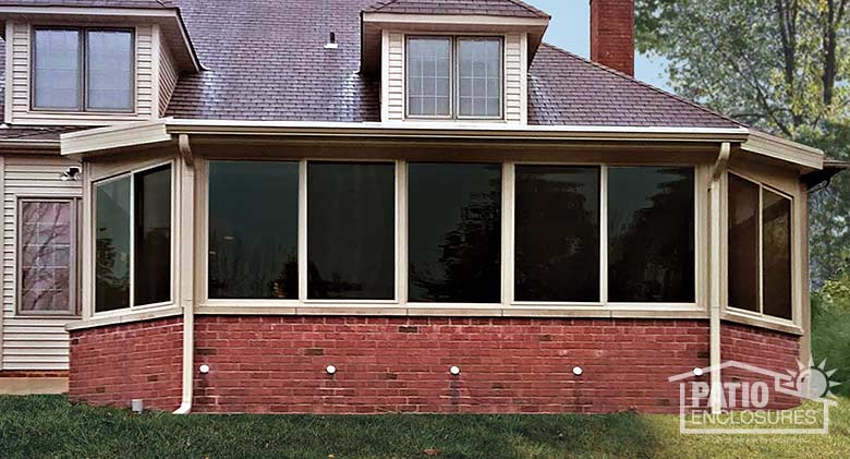 Elite three season room in sandstone enclosing an existing covered patio.