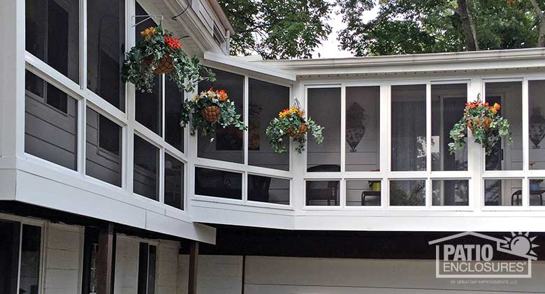 White screen room with knee wall enclosing wraparound, existing covered porch.